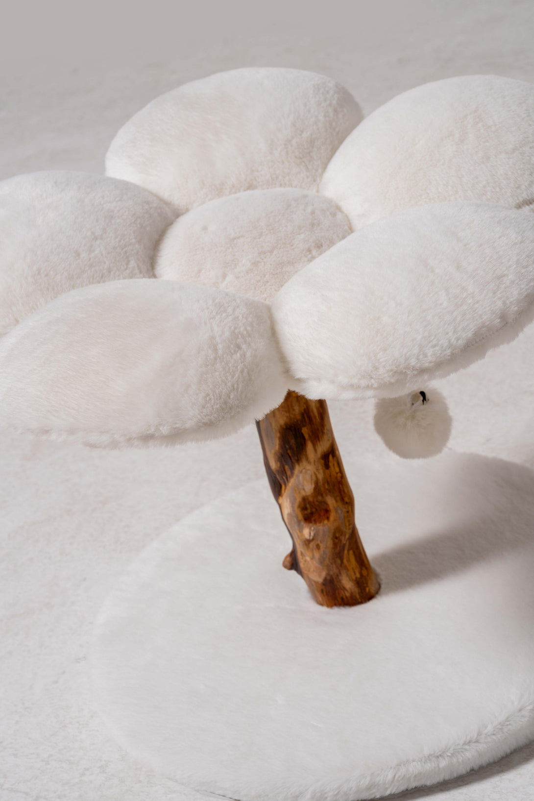Plush bedding on the compact modern cat tree for comfort
