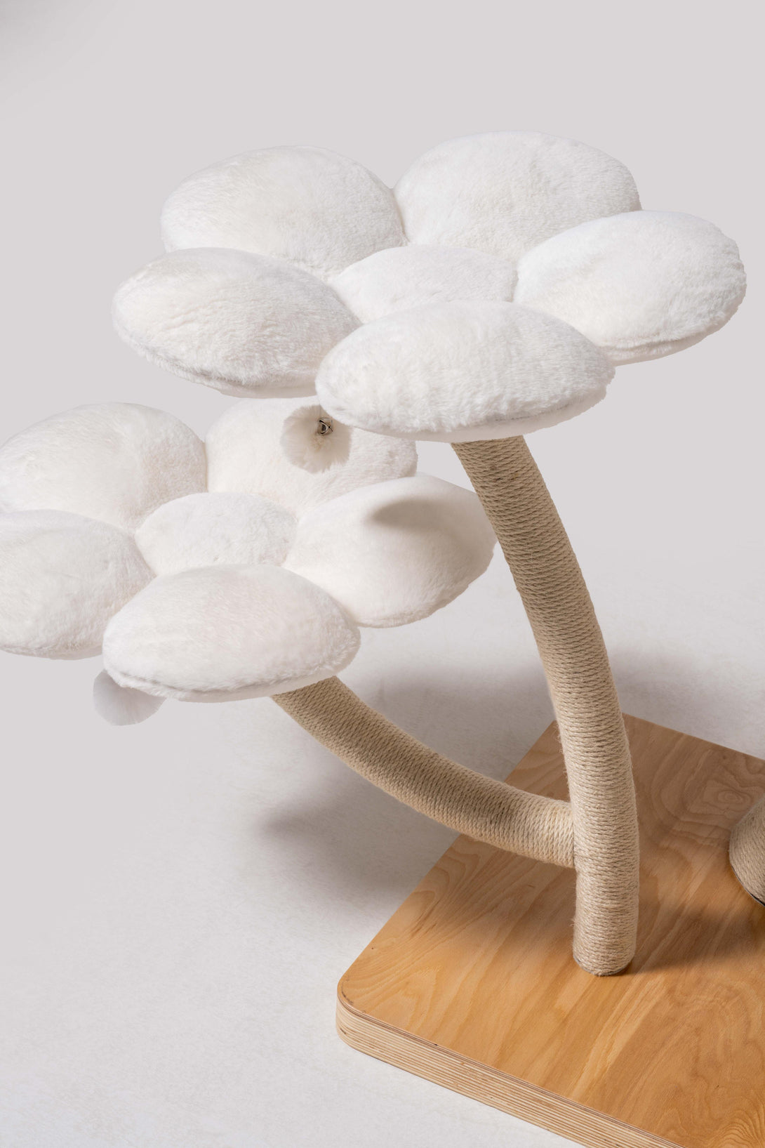 Plush modern cat bed atop the elegant floral cat tree
